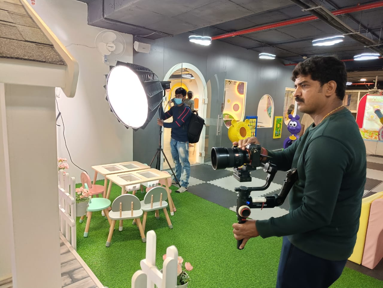 Candid Treasures team preparing lighting and filming a children's shoot in Hyderabad
